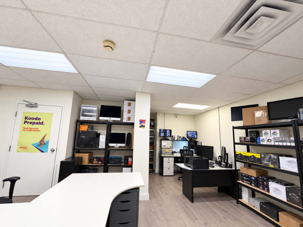 Wide interior view of Moe Repair showing the counter and computer repair area