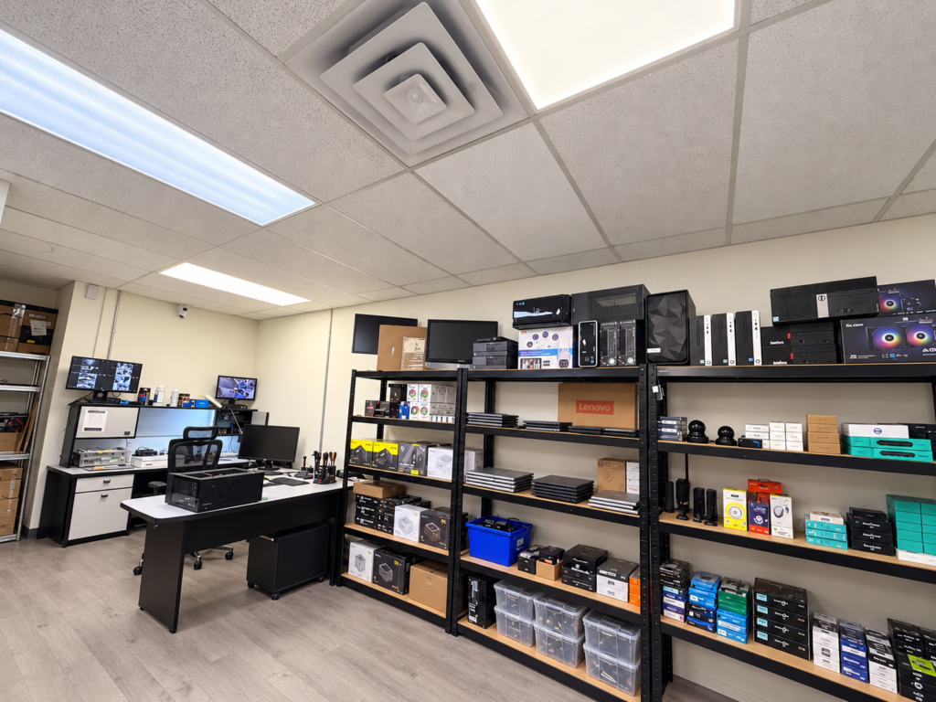 Computer workbench, laptops and parts shelving at Moe Repair