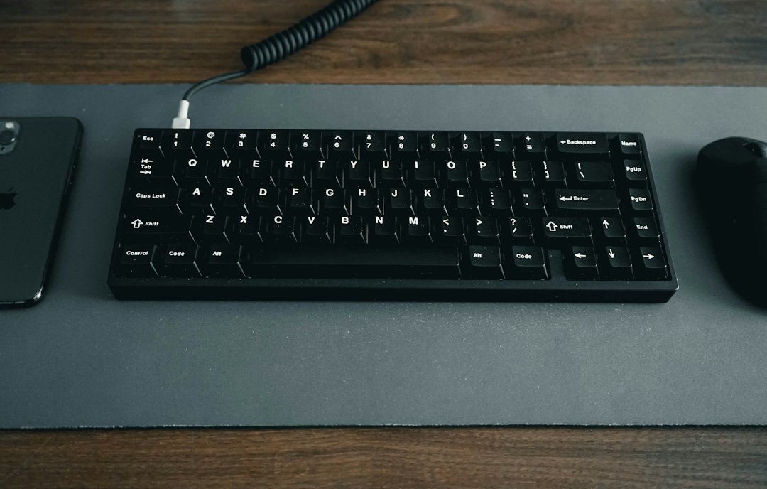 Keyboard and mouse arranged on a desk mat